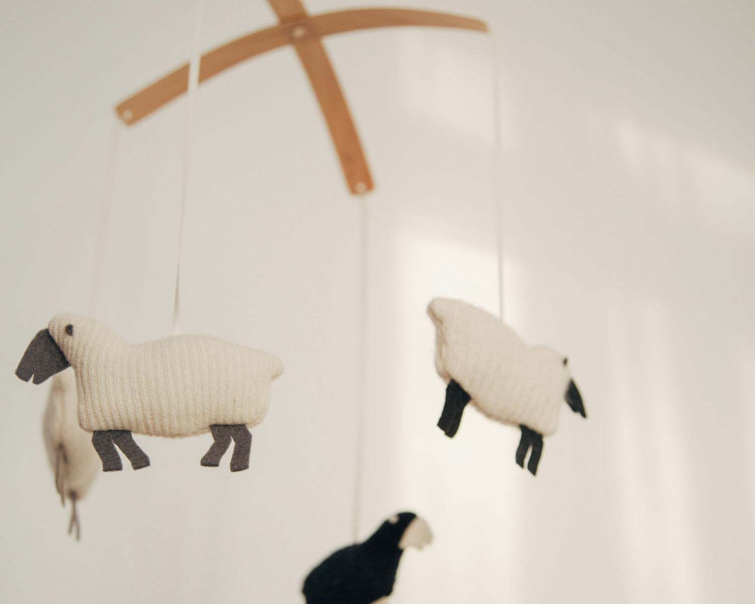 Mobile with sheep and a shepherd on a white background