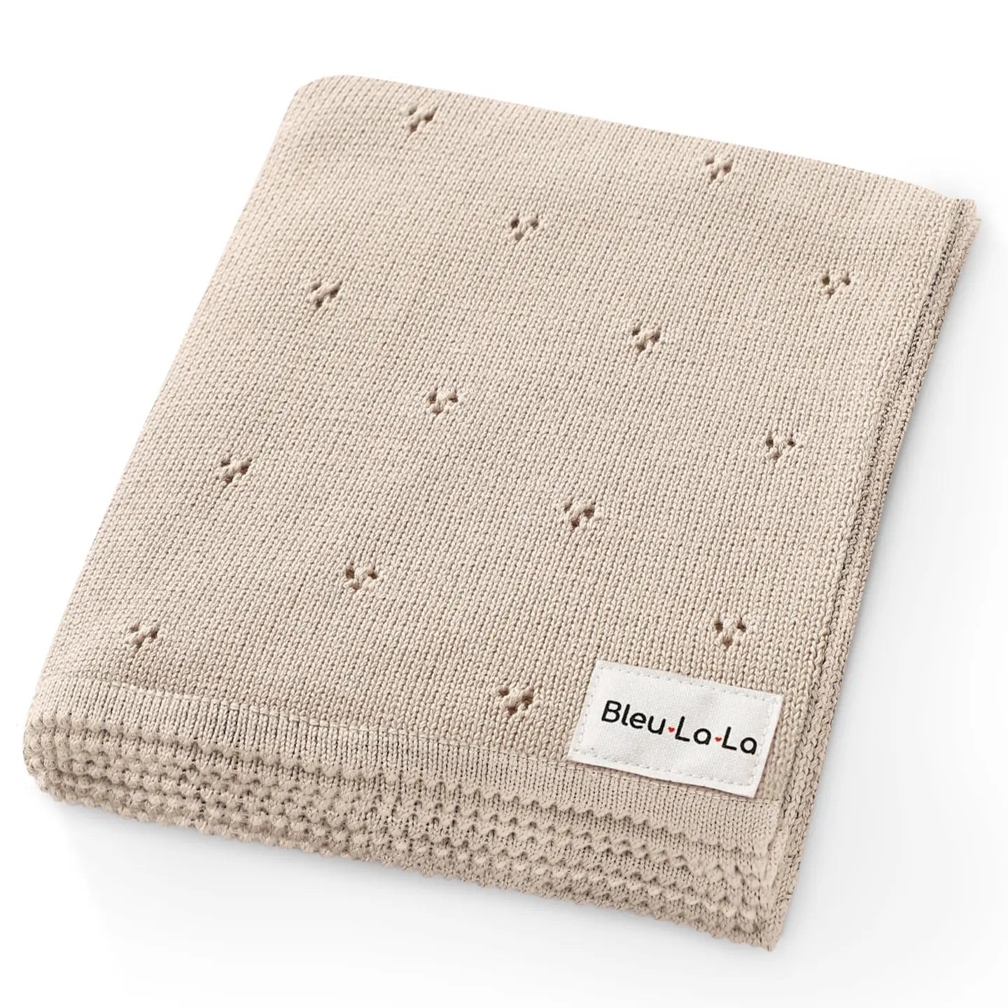 Beige knitted blanket with small star patterns and 'Bleu La La' label on a white background