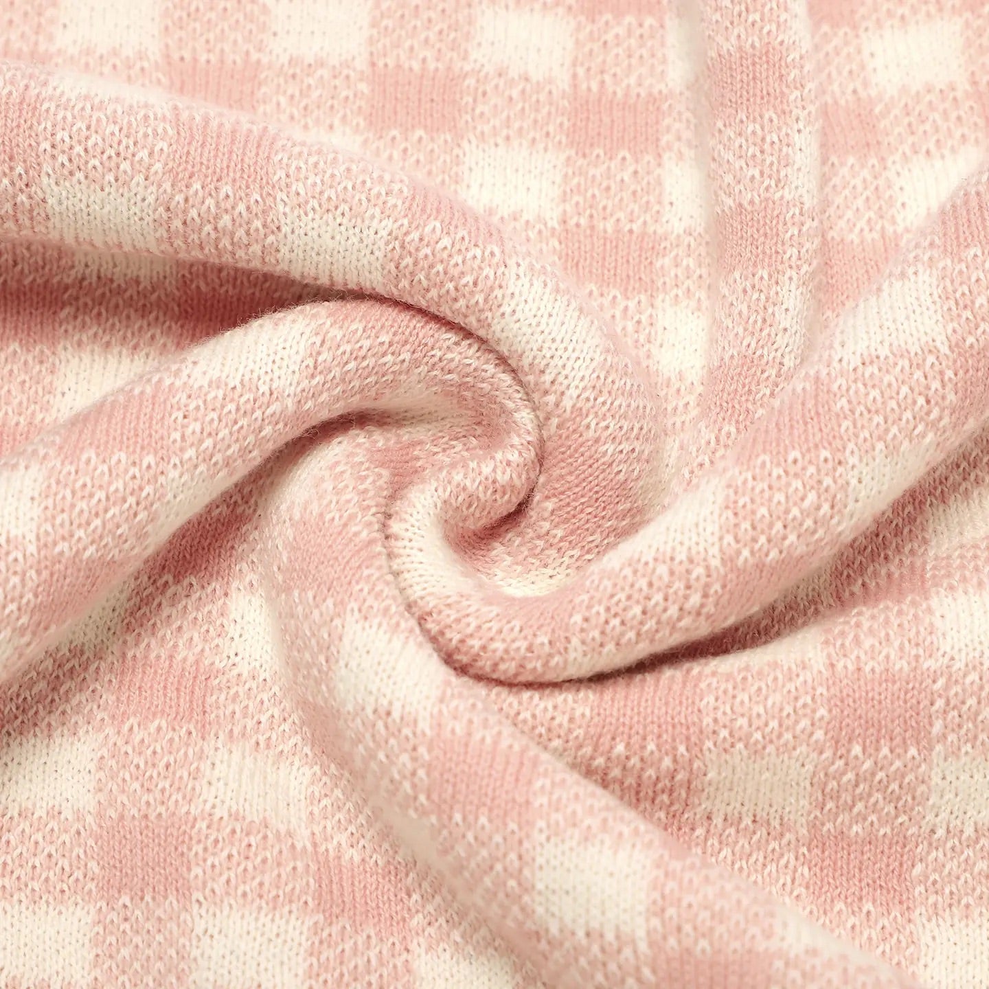 Close-up of pink textured fabric with a plaid pattern