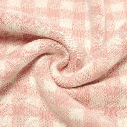 Close-up of pink textured fabric with a plaid pattern