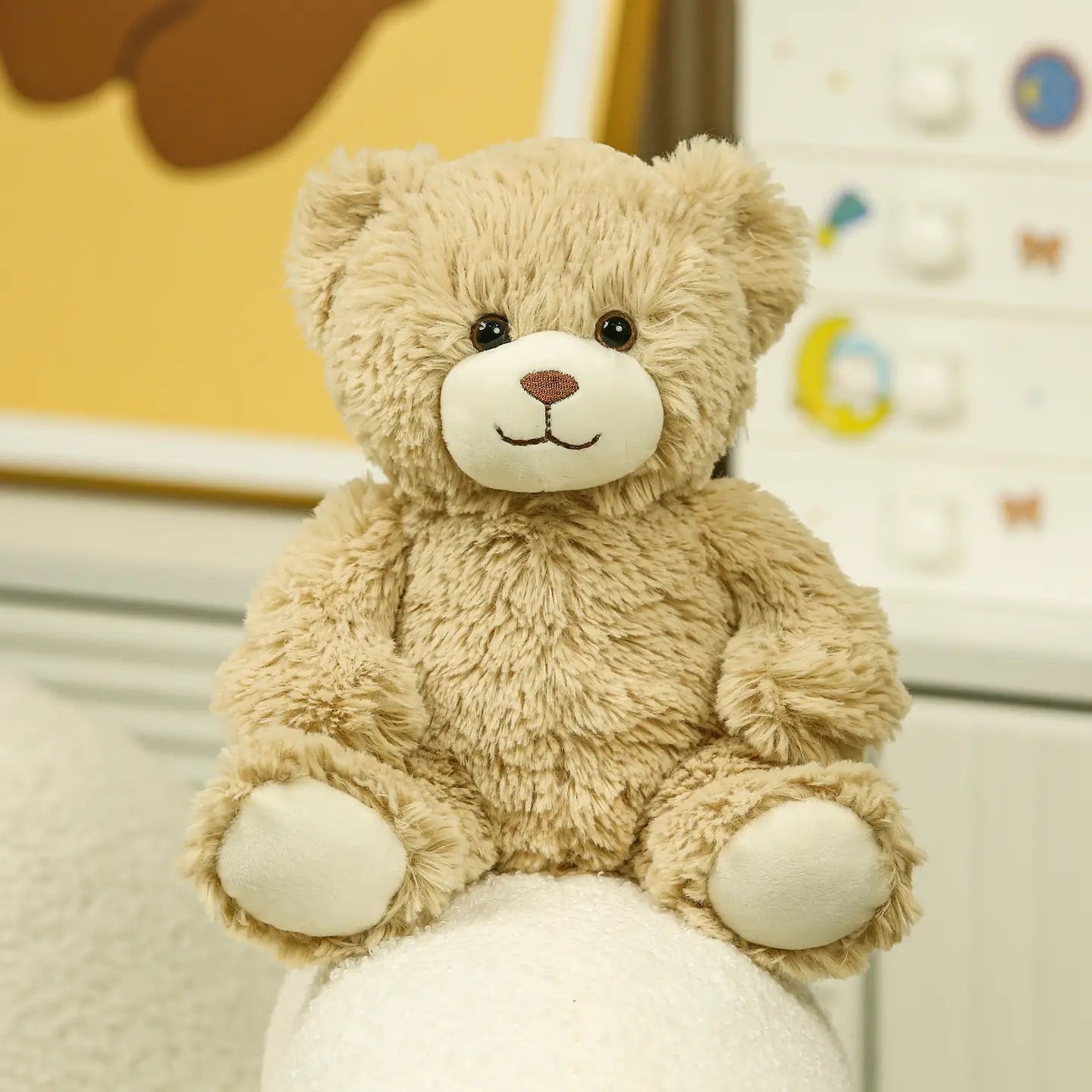 Beige teddy bear plush on a white background, front view sitting position