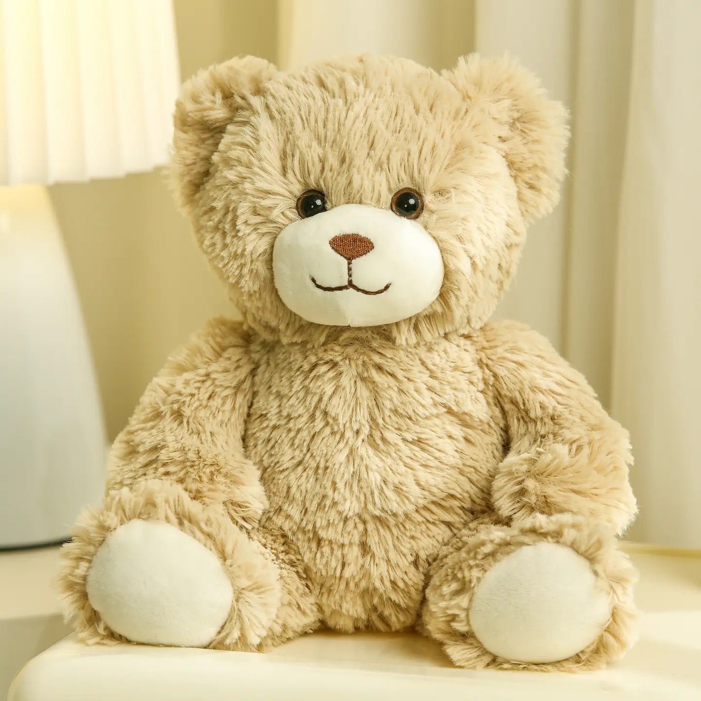 Beige teddy bear plush on a white background, front view sitting position